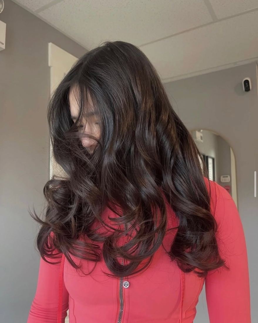 Long dark brown hair with soft curled layers
