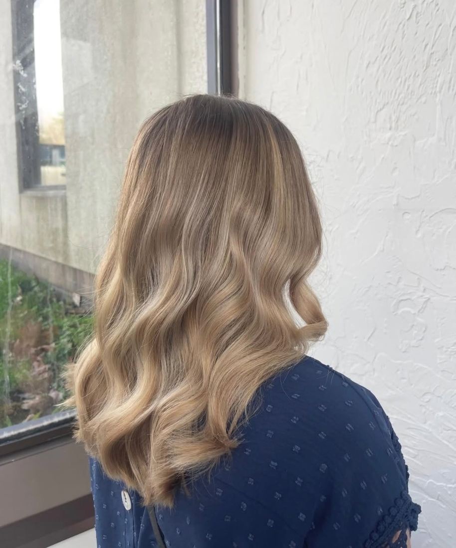 Shoulder-length blonde balayage with loose waves