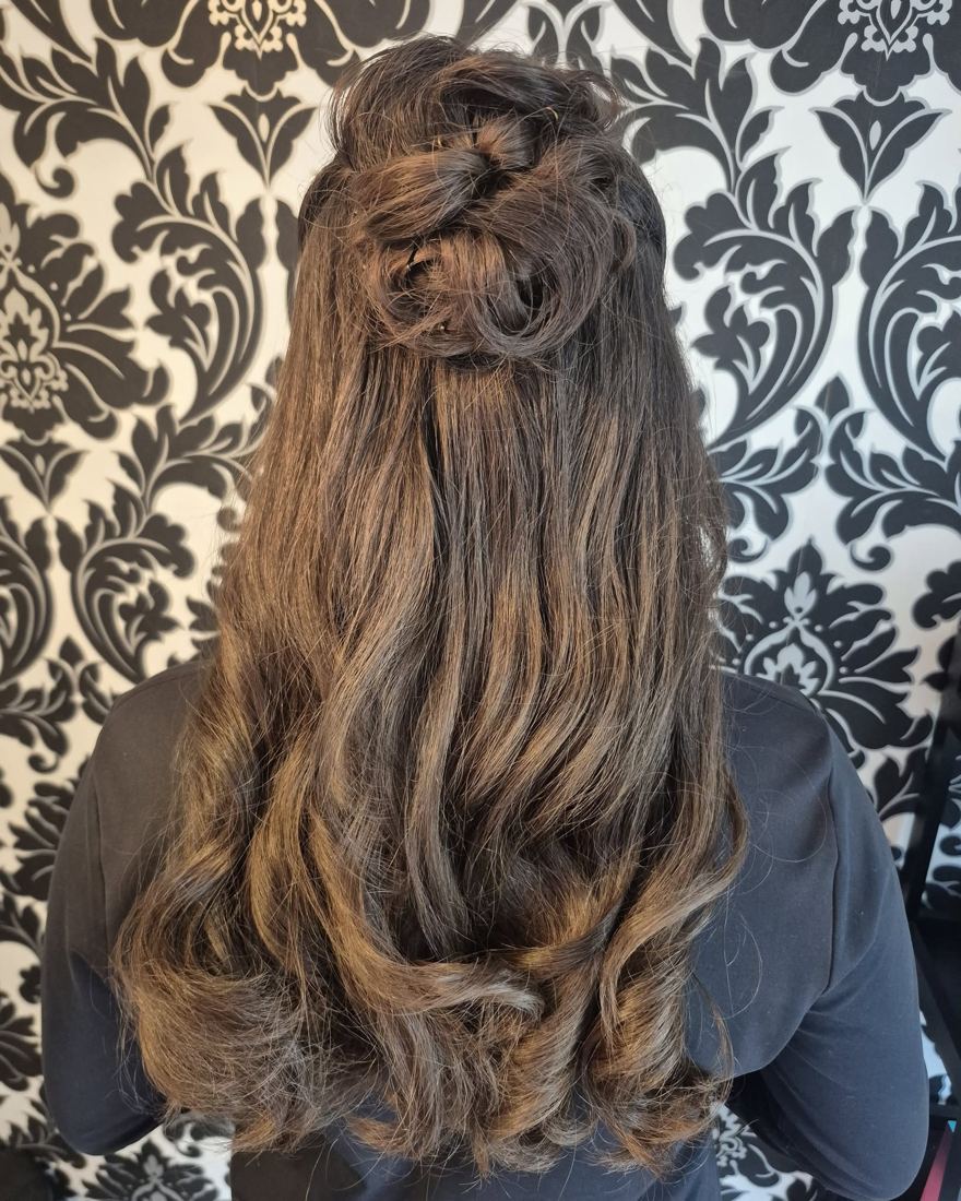 Half-up style with loose curls on long brunette hair