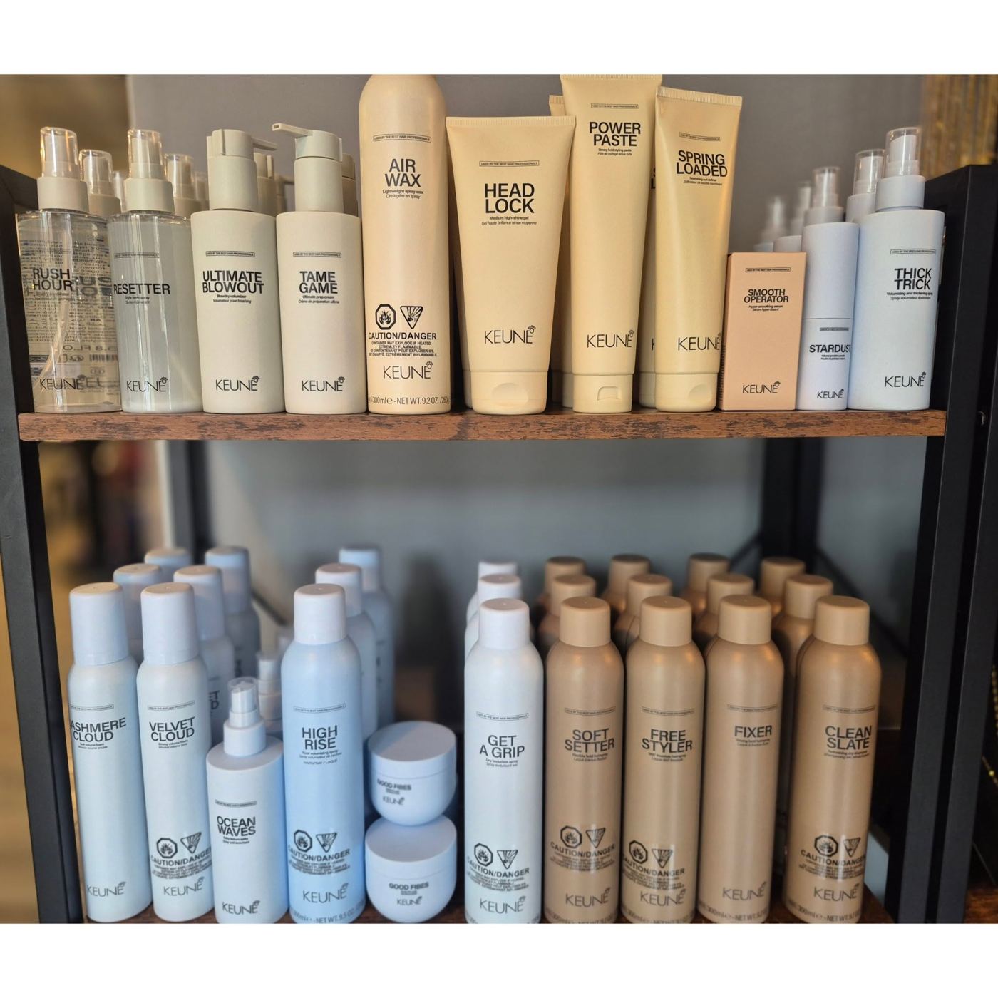 Hair care products lined up on wooden shelves in the salon